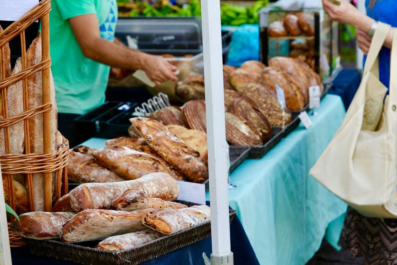 A table with bread on it and people at the side